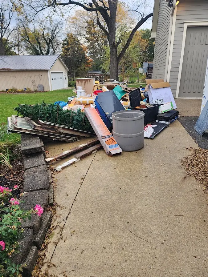 Dumpster being loaded with debris for 12 Yard Dumpster Rental in Argyle